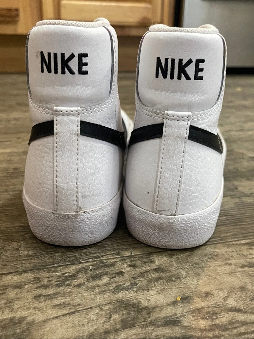 Nike White High-Top Sneakers with Black Swoosh